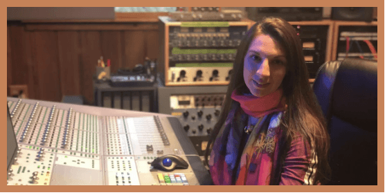 Audio engineer at an SSL recording console in a professional studio